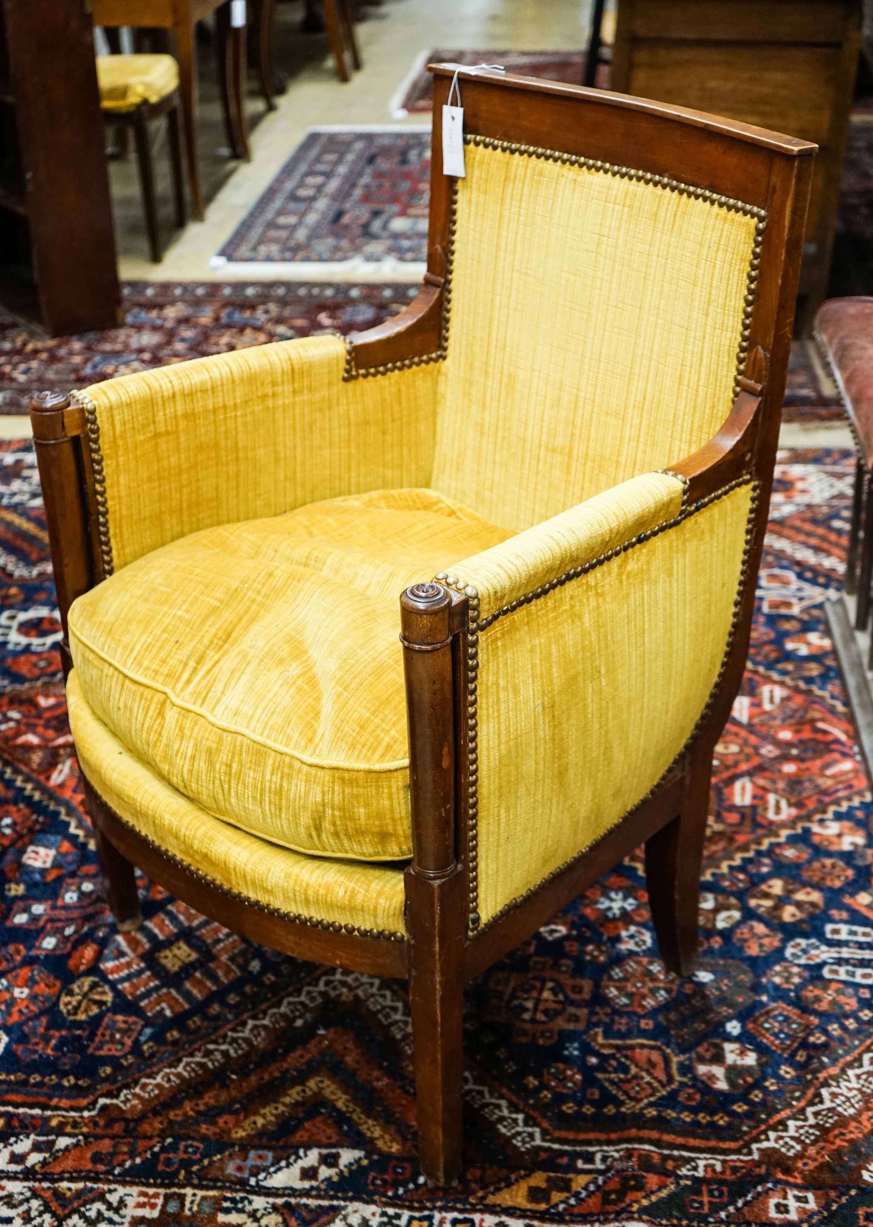 An Empire fruitwood bergere, c.1840, width 62cm, depth 52cm, height 90cm